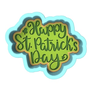 May include: A blue and green layered paper cut-out design with the text "Happy St. Patrick's Day" in a green cursive font.