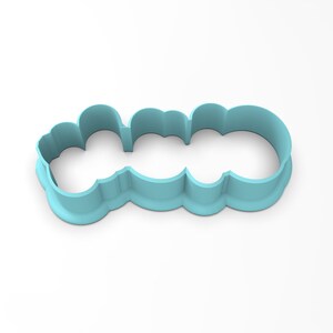 May include: A light blue plastic cookie cutter shaped like the word "LOVE" in a whimsical font.