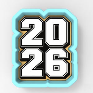 May include: A light blue cookie cutter in the shape of the year 2026. The numbers are white with a black outline and sit on a gold background. The cookie cutter is a light blue color.