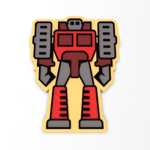 May include: A red and gray robot toy with a yellow background. The robot has a large head with two square eyes and a small mouth. The robot has two arms with large hands and two legs with large feet.