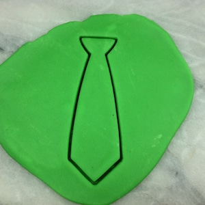 May include: Green fondant with a tie-shaped cutout.