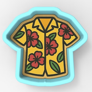 May include: A yellow Hawaiian shirt cookie cutter with red hibiscus flowers and green leaves. The cookie cutter is in the shape of a shirt and is surrounded by a light blue border. The shirt has a black outline.