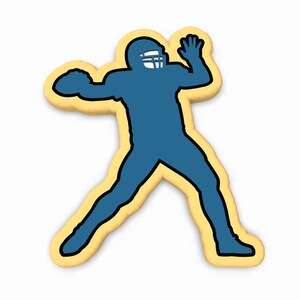 May include: A blue silhouette of a football player throwing a football. The player is wearing a helmet and is in a throwing position. The silhouette is outlined in black and is on a yellow background.