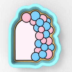 May include: A light blue cookie cutter in the shape of a doorway, decorated with pink and blue balloons. The cookie cutter has a scalloped edge and a light brown border.