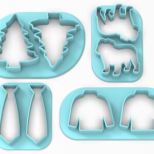 K&ouml;nnte beinhalten: Satz mit vier blauen Plastik-Ausstechformen. Die Ausstechformen sind in Form eines Weihnachtsbaums, einer Krawatte, eines Pullovers und zweier Tiere.