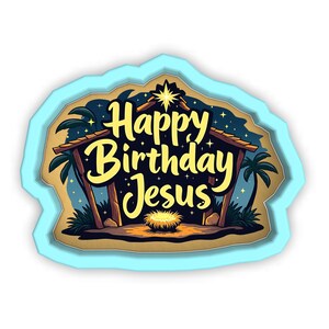 Può includere: Un design a strati con un bordo azzurro presenta una scena della Natività con la scritta "Happy Birthday Jesus" in giallo. La scena comprende una stella, palme e una mangiatoia.