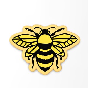 May include: A yellow and black bee with wings outstretched, outlined in black, on a light yellow background.