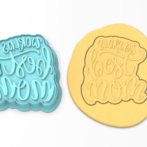 May include: A blue plastic cookie cutter with the words "World's Best Mom" in a cursive font.