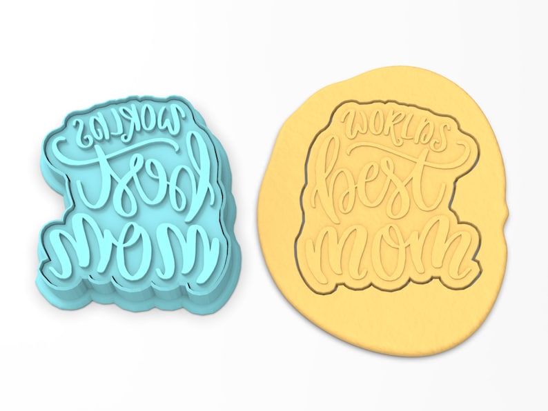 May include: A blue plastic cookie cutter with the words "World's Best Mom" in a cursive font.
