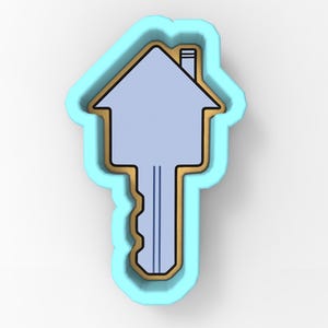 May include: A house-shaped key cookie cutter. The key is light blue with a gold outline and a light blue border. The key has a house-shaped top with a chimney and a key shaft with three vertical lines.