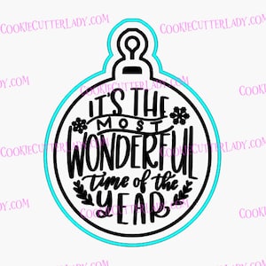 May include: Black and white cookie cutter in the shape of a Christmas ornament with the text "It's the most wonderful time of the year" inside.