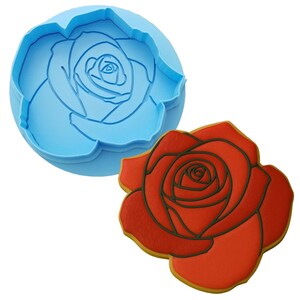 two cookie cutters with a rose design on them
