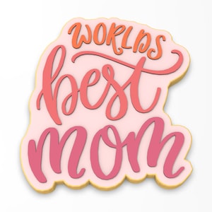 May include: A pink cookie with the words "World's Best Mom" in pink and orange lettering.
