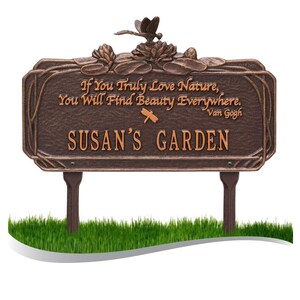 May include: A bronze garden sign with a dragonfly and lily pad design. The sign reads "If You Truly Love Nature, You Will Find Beauty Everywhere. Van Gogh SUSAN'S GARDEN".