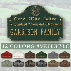 May include: A green metal sign with a gold Celtic knot design and the text "Cead Mile Failte A hundred Thousand Welcomes GARRISON FAMILY". The sign is available in 12 colors.