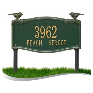 May include: Green metal yard sign with gold lettering. The sign reads "3962 Peach Street" and features two birds perched on leafy branches at the top.