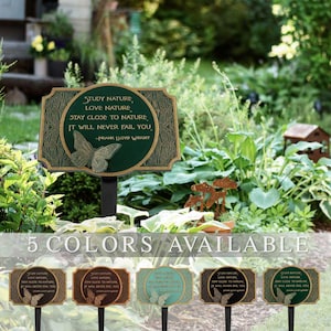 May include: A rectangular garden stake sign with a dark green center and gold border, featuring a butterfly relief and the text: Study nature, love nature, stay close to nature, it will never fail you. -Frank Lloyd Wright. Five color variations.