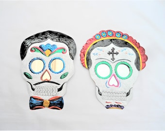frida and catrin couple, pair of catrina and catrin skulls, frida sugar skull, tin sugar skull, day of the dead, mexican tin folk art