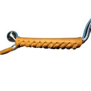 May include: A silver metal handle with a brown leather wrap. The leather wrap is braided and has a small silver bead at the end.