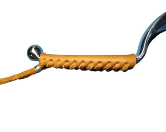 May include: A silver metal handle with a brown leather wrap. The leather wrap is braided and has a small silver bead at the end.