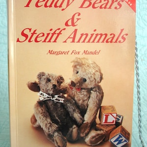 May include: A book titled "Teddy Bears & Steiff Animals" by Margaret Fox Mandel. The cover features two vintage teddy bears and alphabet blocks. The book is a full-color identification guide.