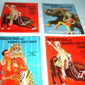 May include: Four vintage Ringling Bros. and Barnum & Bailey Circus souvenir programs and magazines. The covers feature circus performers with animals, including an elephant, tiger, and horses. The covers are red and blue.
