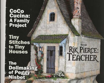 May include: The November 2013 issue of Miniature Collector magazine features a stone cottage model on its cover. The text includes World's Favorite Dollhouse and Miniatures Magazine, CoCo Cucina: A Family Project, Tiny Stitches to Tiny Houses, and Rik Pierce: Teacher. A barcode and a small garden fountain illustration are visible.