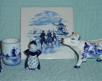 Holland Delft Blue Collection  Windmills and Skaters on Porcelain Cow Creamer, Marked Cup, Tile, and Dutch Couple Salt and PepperShakers