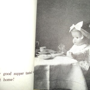 May include: A vintage black and white photograph of a baby seated at a table, wearing a bow in their hair. The baby is eating from a bowl. The table is covered with a white tablecloth. Text on the left side of the image reads, "How good supper tasted...he got home!"