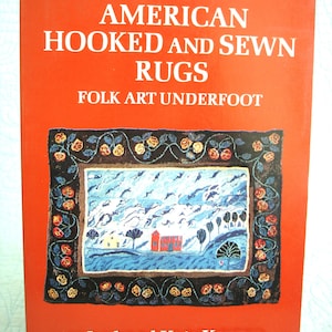 May include: A book cover with the title "AMERICAN HOOKED AND SEWN RUGS" in white text on a bright orange background. The cover features a framed image of a folk art rug with a landscape scene. The authors' names, Joel and Kate Kopp, are at the bottom.
