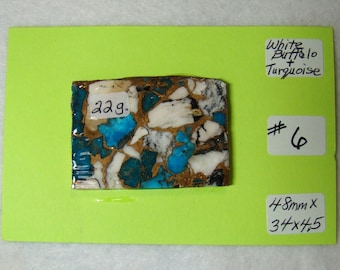 May include: A close-up of a small, rectangular piece of white buffalo and turquoise inlay. The piece is 48mm x 37x45 and weighs 22g. It is labelled "White Buffalo + Turquoise" and "#6".