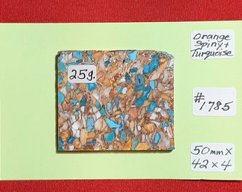 May include: A close-up of a 25g piece of orange spiny and turquoise stone. The stone is a mix of orange, white, and turquoise colours. The stone is labelled "# 785" and measures 50mm x 42 x 4.