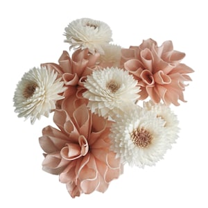 May include: A bouquet of dried flowers in shades of white and peach. The bouquet includes several white sola wood flowers and peach sola wood flowers.