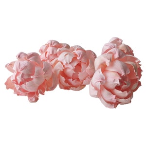 May include: Five pale pink silk peonies, each with delicate petals, arranged in a cluster.