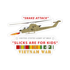 May include: A sticker featuring a tan military helicopter with the text "SNAKE ATTACK". Below the helicopter are the words "UNITED STATES ARMY AT WAR" and "SLICKS ARE FOR KIDS". The words "VIETNAM WAR" are at the bottom.