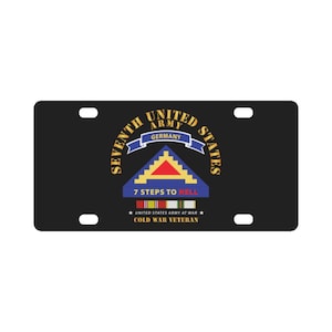 May include: Black license plate featuring the Seventh United States Army emblem. The design includes text that reads "7 Steps to Hell" and "Cold War Veteran". The emblem is in gold, blue, red, and white.