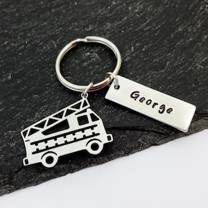 May include: Silver keyring with a fire engine design and a tag that says "George".
