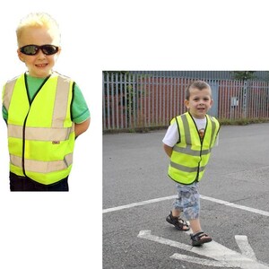 May include: Two children wearing bright yellow safety vests. The vest has reflective strips and a zipper closure. One child is wearing sunglasses.
