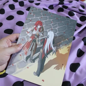 May include: A print depicting two anime-style figures, one with red hair and the other with white hair, in elaborate attire. The background shows a stone wall and scattered rose petals. The artwork has a warm colour palette.