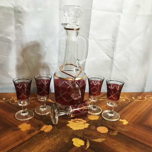 Vintage Red Cut to Clear Decanter and Five Footed Glasses with Gold Trim