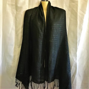 May include: A black scarf with a subtle shimmer and fringe trim.