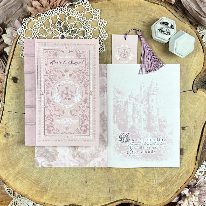 May include: A pink and white wedding invitation with a book-themed design. The front cover features a floral pattern and the text "The Next Chapter Alexis & Samuel Are Getting Married". The back cover features a castle illustration and the text "Once upon a time a girl and a boy fell in love just like the pages out of a storybook."
