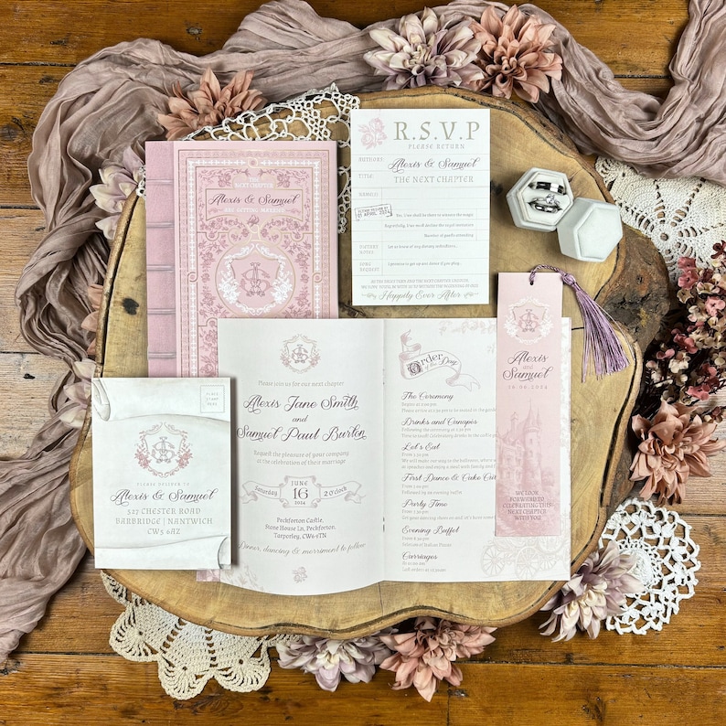 May include: A pink and white wedding invitation suite with a book-themed design. The invitation features a floral pattern and the text "Alexis Jane Smith and Samuel Paul Barker". The RSVP card includes the text "Please return by... Alexis & Samuel The Next Chapter". The bookmark features a castle illustration and the text "Alexis & Samuel".