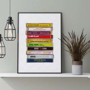 May include: A stack of vintage cassette tapes with various band and song titles. The tapes are arranged vertically, with the top tape showing "BAND NAME SONG OR ALBUM". The tapes are in a variety of colors, including yellow, red, green, blue, and purple.