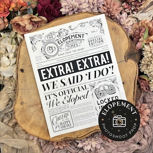 May include: A black and white newspaper-style announcement with the headline "EXTRA! EXTRA! WE SAID 'I DO!'" and the text "IT'S OFFICIAL We Eloped." The announcement is a photoshoot prop, with a round sticker that says "ELOPEMENT PHOTOSHOOT PROP."