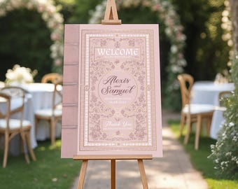 May include: A wedding welcome sign on a wooden easel. The sign is designed to look like a book, with a pink cover and gold lettering that reads "Welcome to the Wedding of Alexis and Samuel". The date is also included.