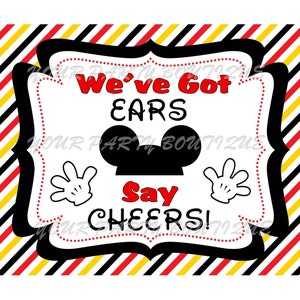 May include: A black and white sign with red accents and a Mickey Mouse head silhouette. The sign says "We've Got Ears Say Cheers!"