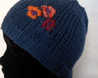 Blue cotton “denim” hat with floral decoration.