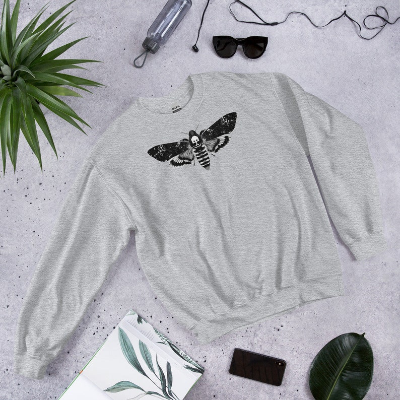 May include: A gray sweatshirt with a black and white print of a death's-head hawkmoth.