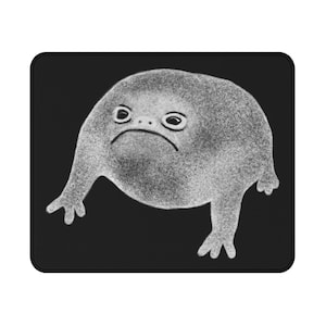 May include: A black and white illustration of a grumpy frog with a round body and short legs. The frog has a frowning expression and large eyes.